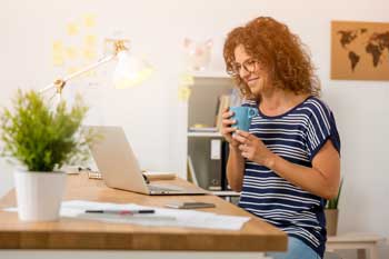 woman-at-her-computer-with-cup-of-coffee